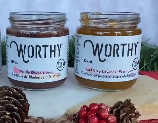 Worthy's Vanilla Rhubarb jam jar and Earl Grey Lavender Peach jam jar with the lids off in a winter festive setting.