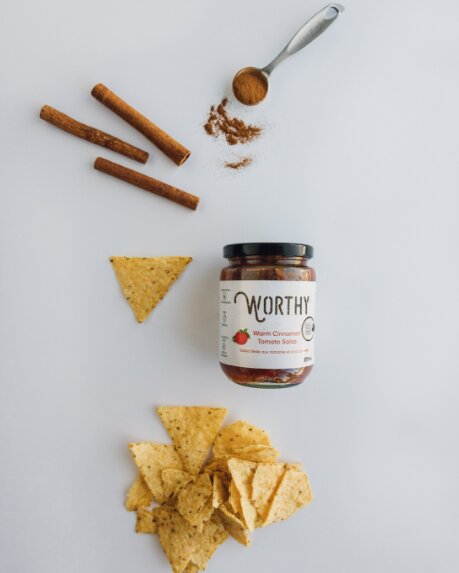 Handful of baked cinnamon and cumin tortilla chips to be served with Worthy's Warm Cinnamon Tomato Salsa.
