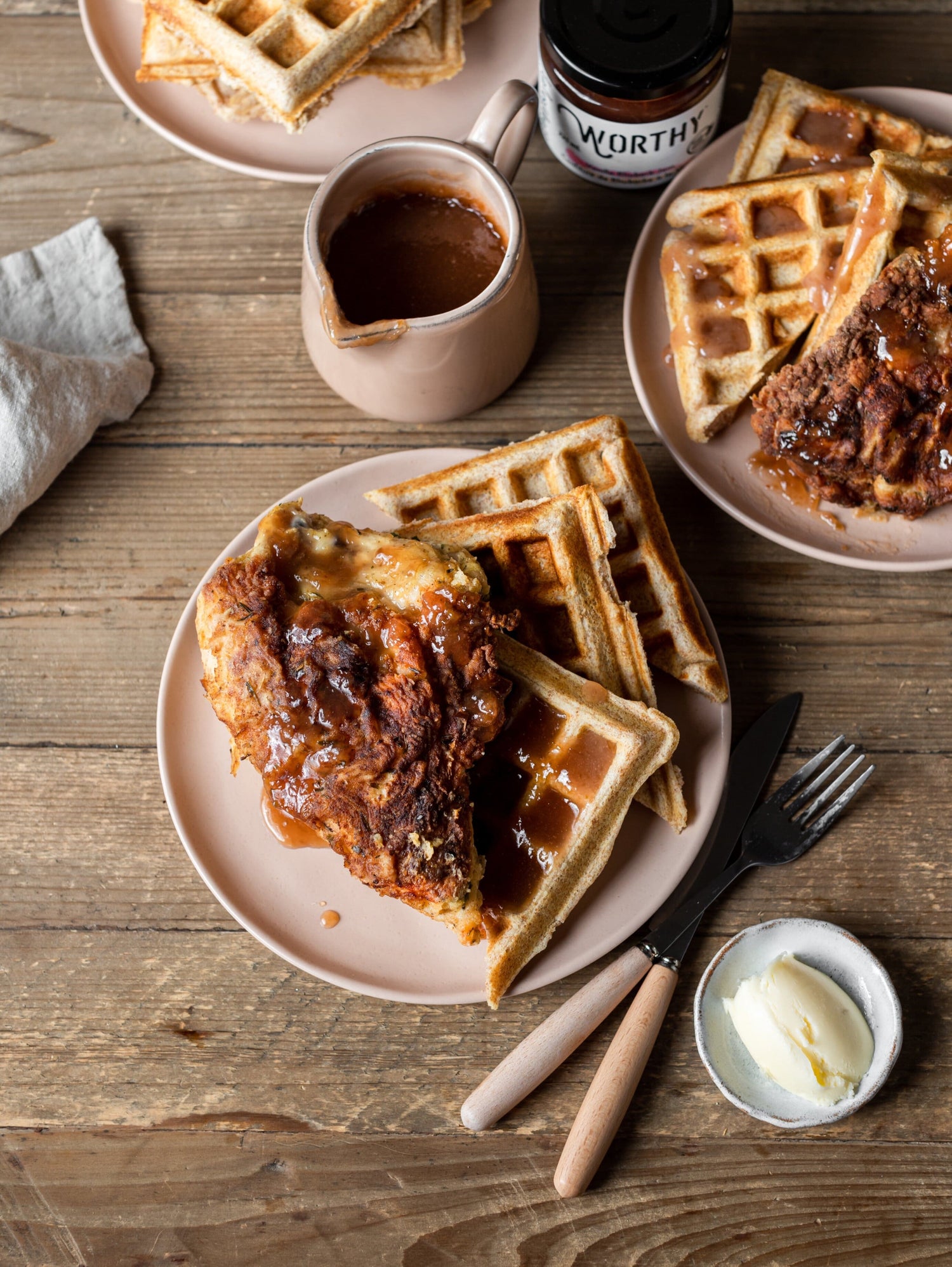 Chicken & waffles drizzled with vanilla rhubarb butter made with Worthy’s Vanilla Rhubarb jam in a rustic setting.