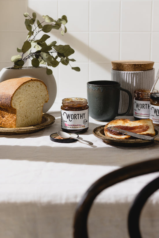 a jar of Worthy's Vanilla Rhubarb jam with some spread on a piece of toast with the other two Worthy jam jars in the background