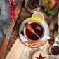 Warm cup of earl grey tea infused with Worthy's Gingersnap Apple Spread in a Christmas setting.