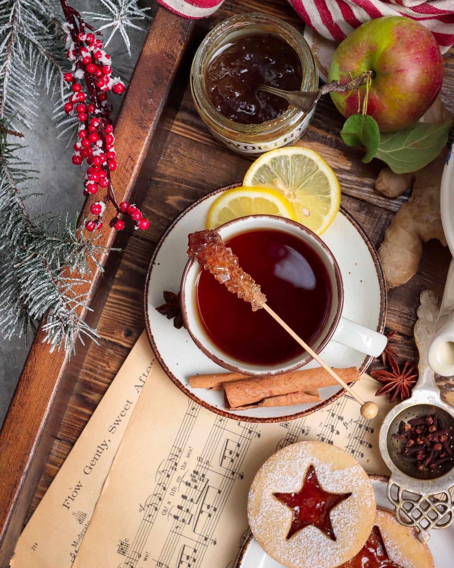 Warm cup of earl grey tea infused with Worthy's Gingersnap Apple Spread in a Christmas setting.