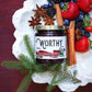 Worthy's Spiced Mixed Berry Spread displayed on a white plate alongside an assortment of strawberries, blackberries and blueberries with cinnamon sticks, star anise, and a decorative pine branch.